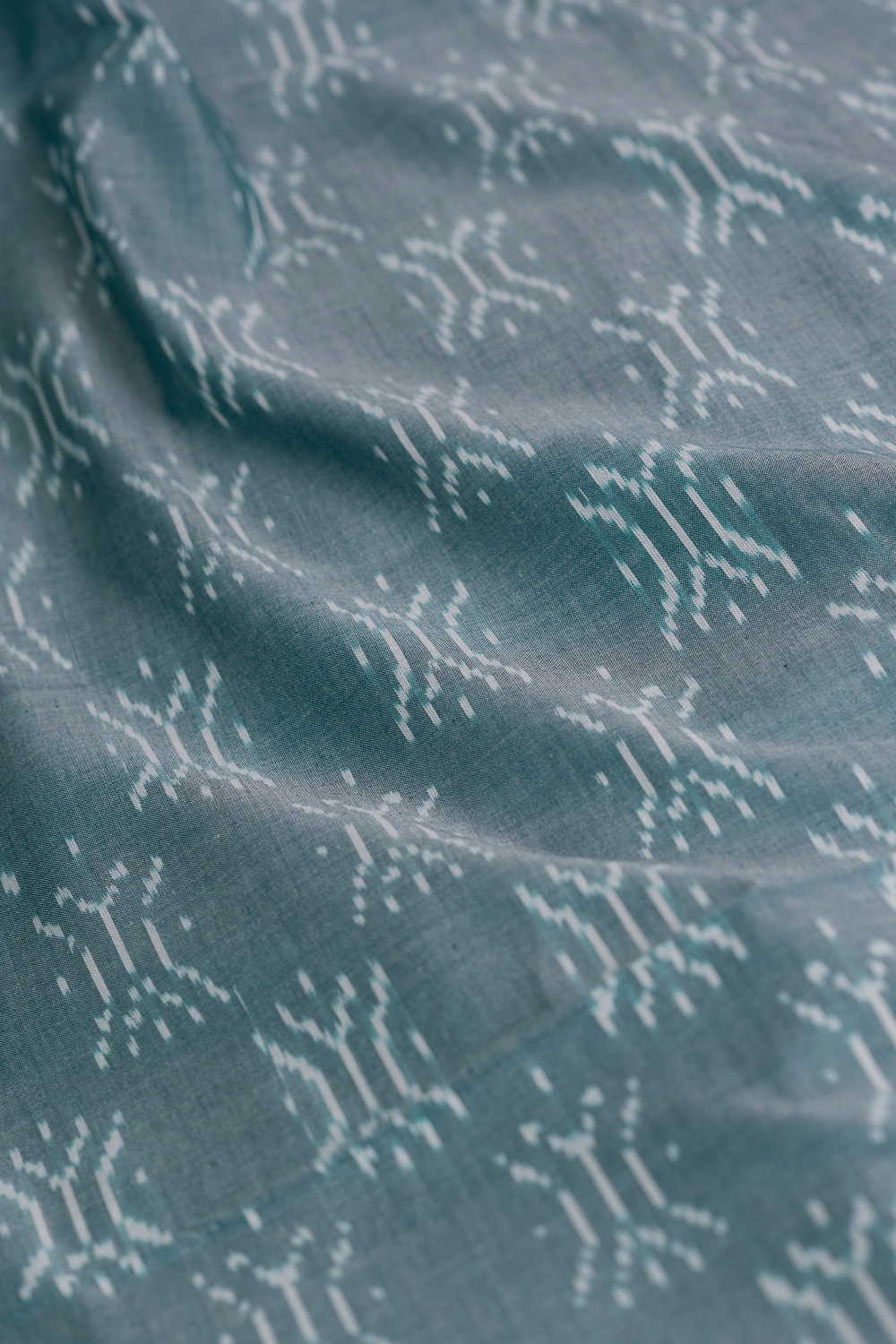 Buttas on Green Mercerized Ikat Cotton Fabric - Image 3